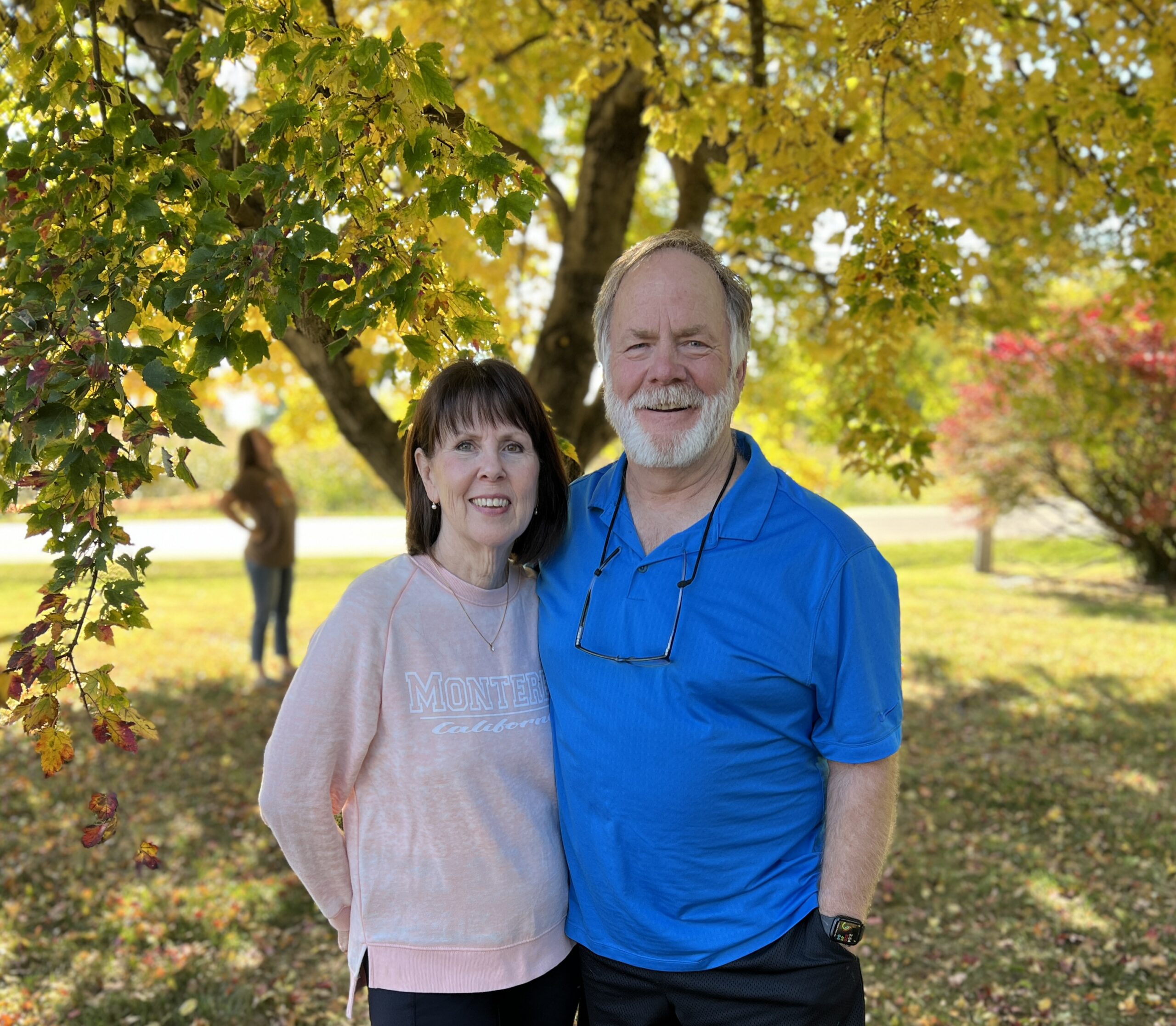 Hollis and Elaine McGehee smiling under autumn trees